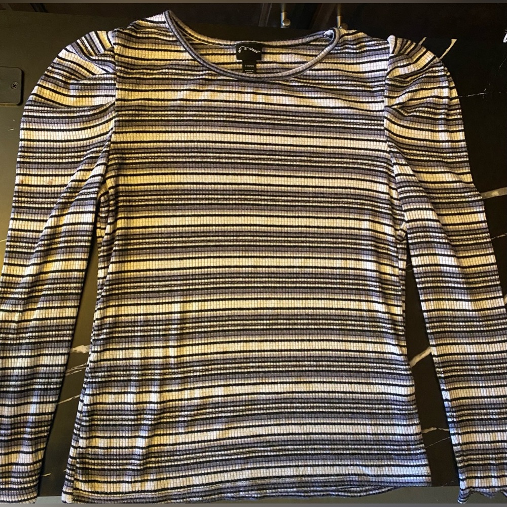 Black and white stripped top with a little bit of gold